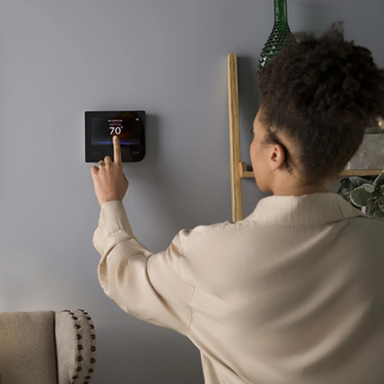 image of Carrier adjusting thermostat